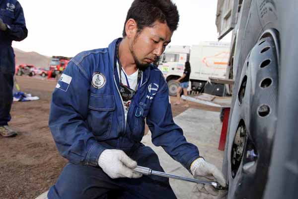 Yamazaki mechanic working on chassis inspection.
