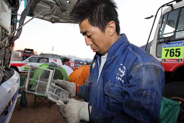 Kitamura mechanic checking the filters.