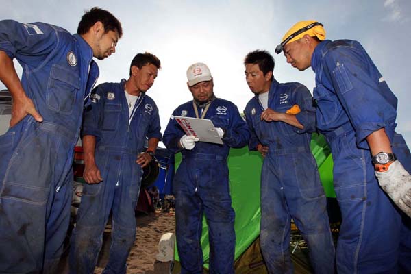 Mechanics checking the service areas.
