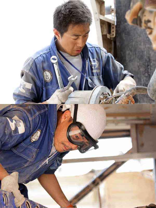 Kitamura mechanic servicing around the king pin of Car 1. / Mizuno mechanic cleaning the inside of the rear body of Car 1.