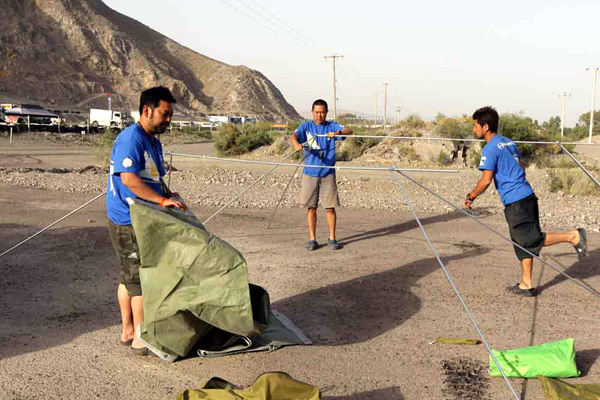 Mechanics putting up tents at the bivouac.